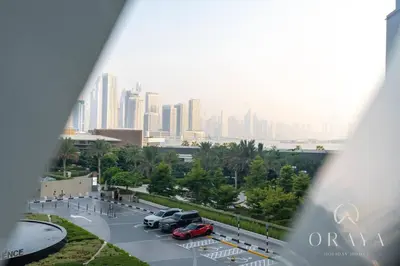 a view of a parking lot with a city in the background at Luxurious Studio In Seven Palm Hotel & Apartments in Dubai