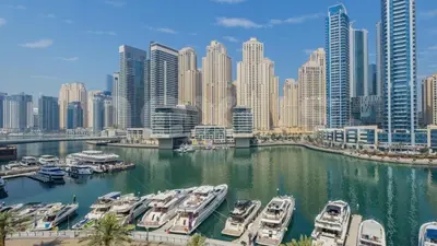 a group of boats docked in a harbor in a city at Dubai Marina, Beach and Metro in Dubai