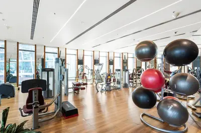 a gym with a lot of exercise equipment at Bright One BDR close to Burj Khalifa & Dubai Mall in Dubai