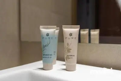 two tubes of sunscreen sitting on a bathroom sink at Studio - Azizi Riviera 37 in Dubai