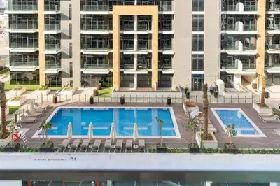 an overhead view of a swimming pool in front of a building at Studio - Azizi Riviera 37 in Dubai