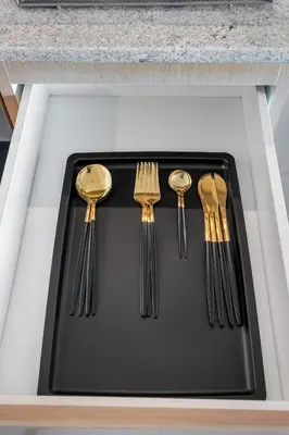 a tray with forks and spoons on a counter at Cosmic Sky Suite High floor 1BR- Dubai Mall Access by Maxx Value Homes in Dubai