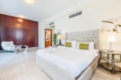 a large white bedroom with a large bed at Extra Spacious Home with Stunning Marina Views in Dubai