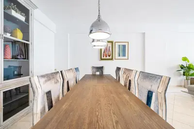 a dining room with a long table and chairs at Extra Spacious Home with Stunning Marina Views in Dubai