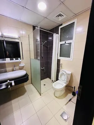 a bathroom with a shower and a toilet and a sink at Luxury Studio Apartment In Dubai Marina in Dubai