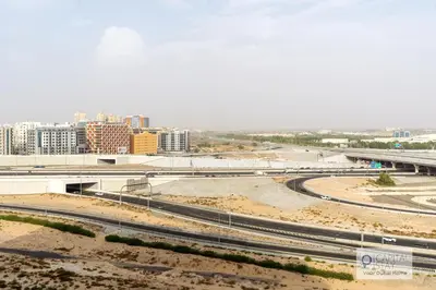 a view of a city with a bridge and train tracks at Capital Stay - Cozy Studio in Liwan Dubai in Dubai