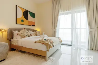 a bedroom with a bed and a large window at Capital Stay - Cozy Studio in Liwan Dubai in Dubai