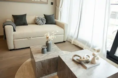 a living room with a couch and a coffee table at WelHome - LOCI Residences in Dubai