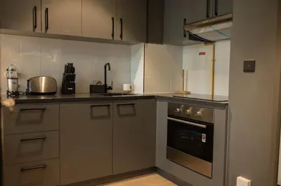 a kitchen with a stove and a counter top at WelHome - LOCI Residences in Dubai