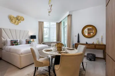 a living room with a bed and a table and chairs at Old Form in Dubai