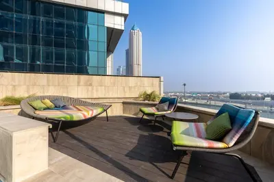 a patio with two chairs and a table on a building at Old Form in Dubai