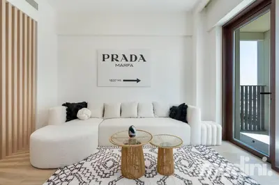 a living room with a white couch and a table at 1-Bedroom - in Emaar Creek Harboor in Dubai