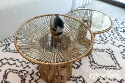 a wicker chair with a vase sitting on top of it at 1-Bedroom - in Emaar Creek Harboor in Dubai
