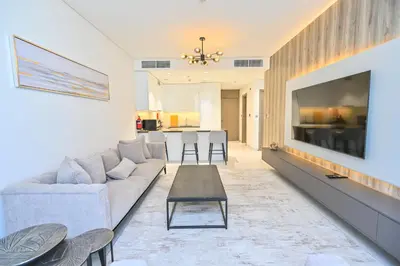 a living room with a couch and a table at Centrally Located 1 Bedroom in District One Meydan in Dubai