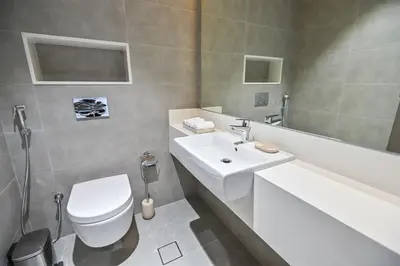 a bathroom with a white sink and a toilet at Magnificent 2BR in District One Meydan in Dubai