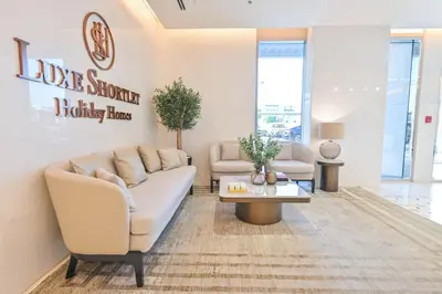 a living room with a couch and a table at Unique 1BR in District One Meydan in Dubai