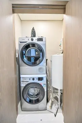 a washer and dryer in a room at 1BR by Dubai Crystal Lagoon in District One Meydan in Dubai