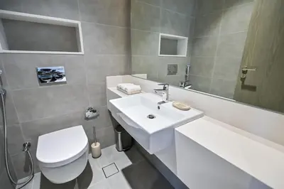 a bathroom with a white sink and a toilet at 1BR by Dubai Crystal Lagoon in District One Meydan in Dubai