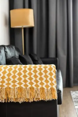 a living room with a couch and a lamp at Bright 1Bdr at Fortunato in Dubai