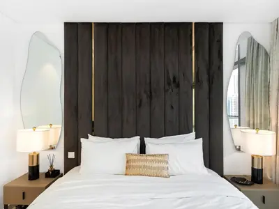a bedroom with a white bed with two lamps at Luxury Apartments at Paramount Midtown by Dale Lee in Dubai