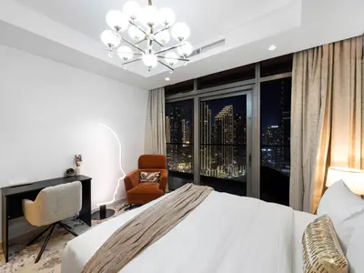 a bedroom with a white bed and a large window at Luxury Apartments at Paramount Midtown by Dale Lee in Dubai