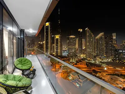 a room with a view of a city at night at Luxury Apartments at Paramount Midtown by Dale Lee in Dubai
