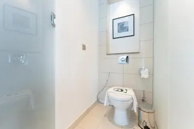 a bathroom with a toilet and a shower at 3 Bed in DAMAC Paramount by PK Holidays in Dubai