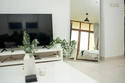 a living room with a mirror and a couch at AWS Holiday Homes - Stylish Gem in the Palm in Dubai