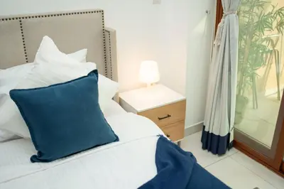 a bedroom with a blue pillow on a bed at AWS Holiday Homes - Stylish Gem in the Palm in Dubai