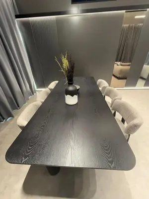 a black table with chairs and a vase on it at Luxury 2BR Close to Sheikh Zayed Rd, Prime Location, Burj View Opposite Metro in Dubai