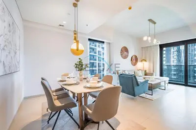 a dining room and living room with a table and chairs at Splendid 2BR Apartment at Act One Act Two Tower 2 in Downtown Dubai by Deluxe Holiday Homes in Dubai