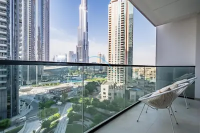 a chair on a balcony with a view of a city at Splendid 2BR Apartment at Act One Act Two Tower 2 in Downtown Dubai by Deluxe Holiday Homes in Dubai