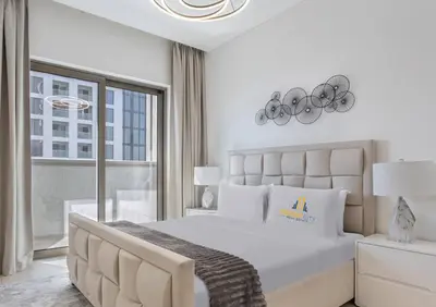 a white bedroom with a large bed and a window at Fully Furnished 2 Bed in Sobha Creek Vista Reserve, Hosted by Desert City Stays in Dubai