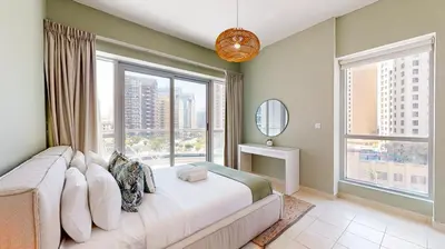 a bedroom with a large bed and large windows at The Point Tower - Vibrant One Bed in Marina in Dubai