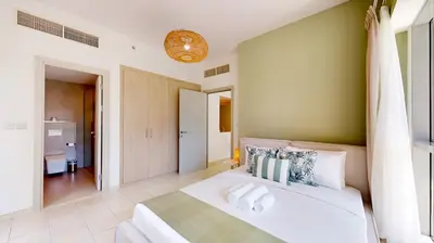 a bedroom with a large white bed in a room at The Point Tower - Vibrant One Bed in Marina in Dubai