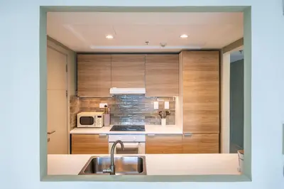 a kitchen with a sink and a microwave at The Point Tower - Vibrant One Bed in Marina in Dubai