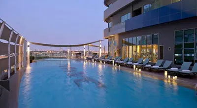 a large swimming pool on the side of a building at The Signature - Two Bedroom in Downtown Dubai in Dubai