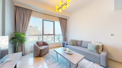 a living room with a couch and a table at Bay Central 1 - One Bed with Stunning Marina View in Dubai