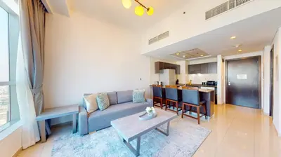 a living room with a couch and a table at Bay Central 1 - One Bed with Stunning Marina View in Dubai