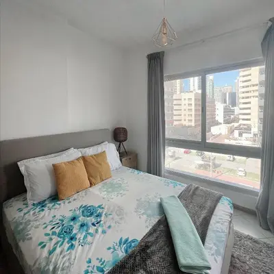 a bedroom with a bed and a large window at Fully Furnished Marina View - 1 Bedroom Apartment in Dubai