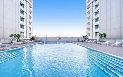a swimming pool in the middle of a building at Stylish 2BR Escape 2 Balconies Pool View in Dubai