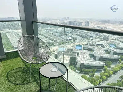 a chair sitting on top of a building at Stylish 2BR Escape 2 Balconies Pool View in Dubai