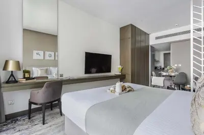 a hotel room with a bed and a television at Frank Porter - Damac Prive A in Dubai