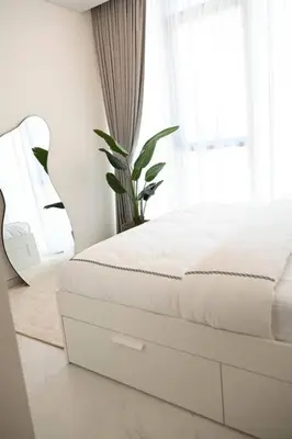 a white bed in a room with a window at 610 lagoon views in Dubai