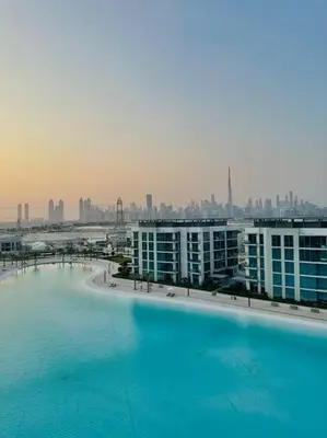 a large swimming pool with a city in the background at 610 lagoon views in Dubai