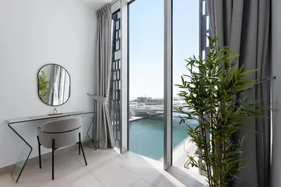 a room with a desk and a large window at Stayis -Studio in Twisted Tower Dubai Marina in Dubai
