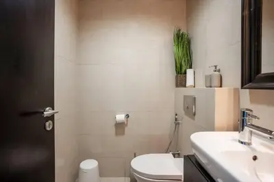 a bathroom with a toilet and a sink at Duplex Suite in 5-Star Movenpick Hotel in Dubai