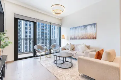 a living room with a couch and a table at Nicely Furnished 2BR Home in Dubai Hills in Dubai