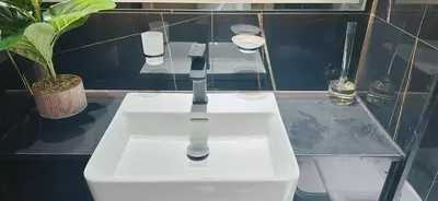 a white sink in a bathroom with a plant at Bright & Cozy 1br Jvc Balcony Free Parking in Dubai