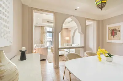 a living room with a white table and chairs at Souk Al Bahar Home with direct Dubai Mall Access in Dubai